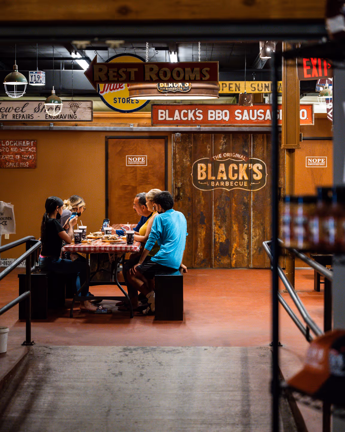 Black's BBQ Employee celebrating with a beer & brisket